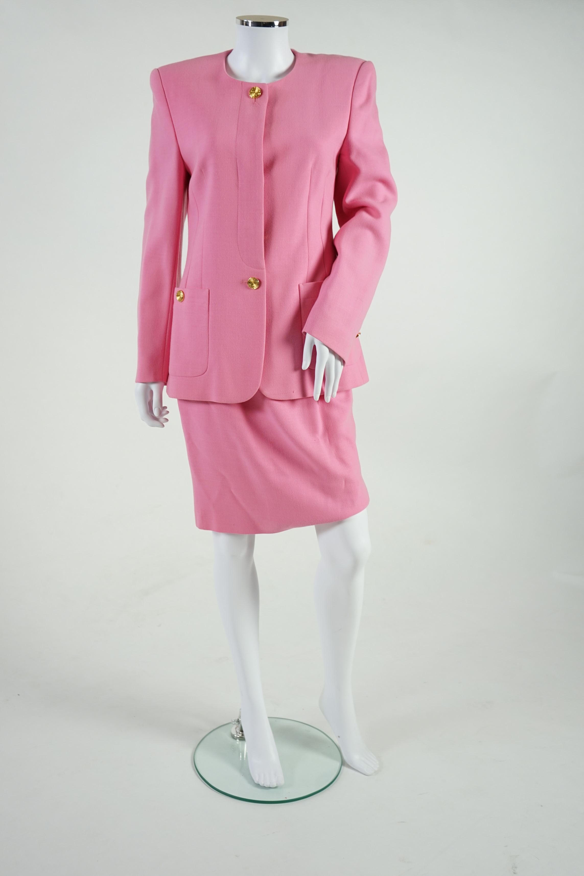 A pink Escada suit with a silk blouse top. Proceeds to Happy Paws Puppy Rescue